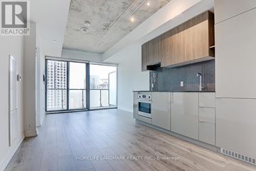 Toronto (Mount Pleasant West) condo for rent - A spacious kitchen with white cabinets and a large window.