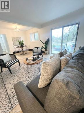 Kitchener apartment for rent - A living room with a grey sofa and a patterned rug.