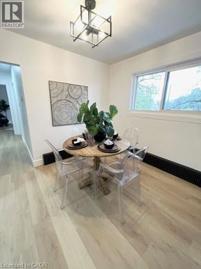 Kitchener apartment for rent - A dining room with a wooden table and chairs.