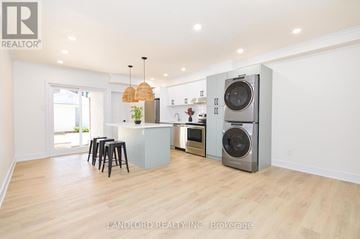 Toronto (Corso Italia-Davenport) triplex for rent - A modern kitchen with a washer and dryer built in.