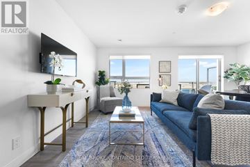 Brampton (Brampton West) house for rent - A living room with a blue couch and a coffee table.