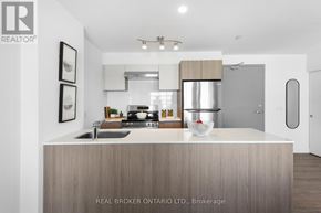 Brampton (Brampton West) house for rent - A modern kitchen with a wooden island and stainless steel appliances.