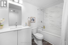 Brampton (Brampton West) house for rent - A white bathroom with a marble wall and a toilet.