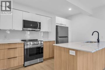 Woodstock apartment for rent - A modern kitchen with wooden cabinets and stainless steel appliances.