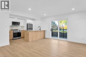 Woodstock apartment for rent - A spacious kitchen with wooden floors and a large island.