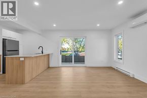 Woodstock apartment for rent - A realtor's office with a wooden reception desk and a view of a balcony through the window.