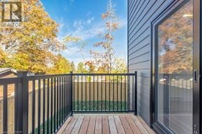 Woodstock apartment for rent - A balcony with a black railing and a glass door.