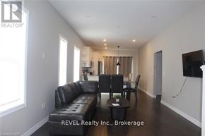 Welland (Lincoln/Crowland) apartment for rent - A living room with a black leather couch and a wooden coffee table.