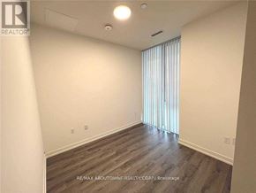 Toronto (Waterfront Communities) condo for rent - A room with wooden flooring and a window with blinds.