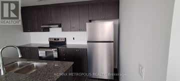 Brampton (Bram East) townhouse for rent - A kitchen with a stainless steel refrigerator and a sink.