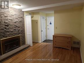 Mississauga (Erin Mills) apartment for rent - A room with a fireplace and a wooden floor.