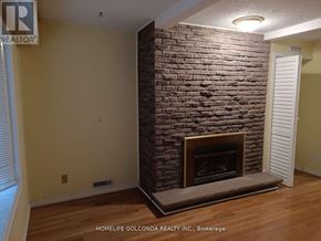 Mississauga (Erin Mills) apartment for rent - A room with a fireplace and a sign that says "REALTOR".