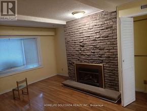 Mississauga (Erin Mills) apartment for rent - A room with a fireplace and a chair.