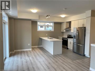 Kitchener townhouse for rent - A kitchen with a refrigerator, stove, and oven.