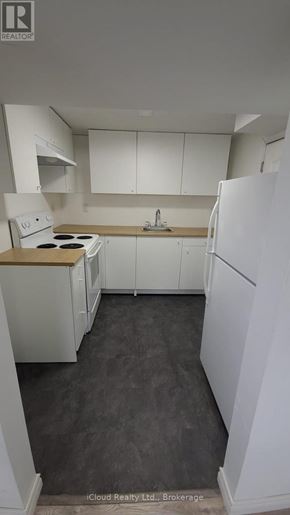 Hamilton (Stoney Creek Mountain) apartment for rent - A kitchen with white appliances and cabinets.