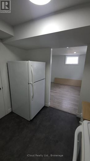 Hamilton (Stoney Creek Mountain) apartment for rent - A white refrigerator in a room with a small window.