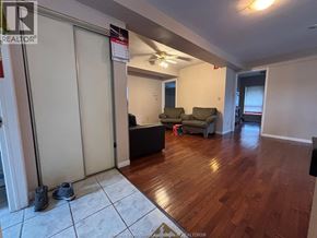 Windsor apartment for rent - A living room with a couch, a chair, and a ceiling fan.