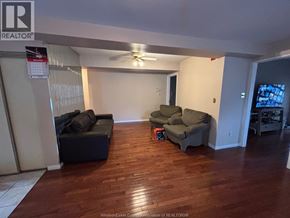 Windsor apartment for rent - A living room with a black couch and a green couch.