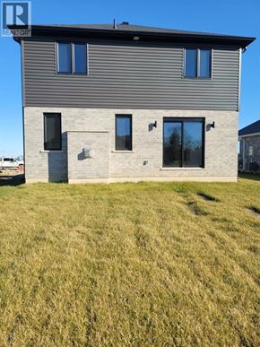 Plympton-Wyoming apartment for rent - A modern house with a grey facade and large windows.