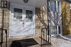 Ottawa apartment for rent - A house with a white door and a window with a view of trees.