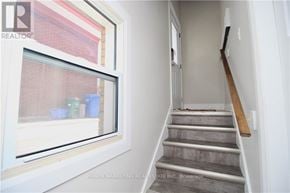 Ottawa apartment for rent - A staircase with a wooden handrail and concrete steps.