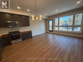 Ottawa apartment for rent - A well-lit, spacious kitchen and living room with wooden flooring and modern appliances.