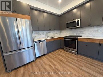 Ottawa apartment for rent - A kitchen with a stainless steel refrigerator and microwave.