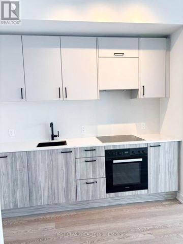 Toronto (Banbury-Don Mills) condo for rent - A kitchen with white cabinets and a wooden counter.