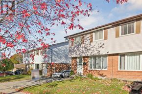 Oshawa (Donevan) apartment for rent - A tree with red leaves is in front of a building.