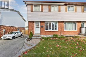 Oshawa (Donevan) apartment for rent - A white car is parked in front of a brick house.
