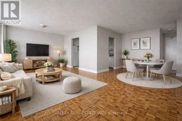 Toronto (Rockcliffe-Smythe) condo for rent - A living room with a wooden floor and a television on the wall.