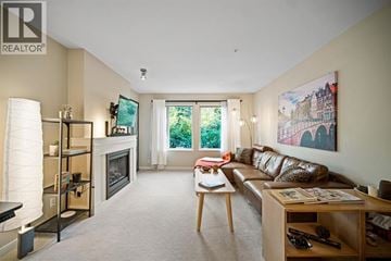 Coquitlam apartment for rent - A living room with a couch, a fireplace, and a painting on the wall.