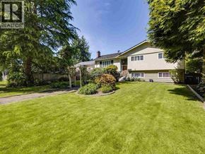 Vancouver apartment for rent - A well-maintained lawn in front of a house with a realtor sign.