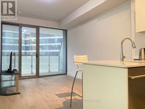 Toronto (Bay Street Corridor) condo for rent - A kitchen with a sink, a chair and a window with a view of a city.