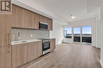 Toronto (Rouge) condo for rent - A kitchen with wooden cabinets and a stove top oven.