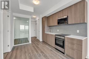 Toronto (Rouge) condo for rent - A kitchen with wooden cabinets and a stainless steel oven.
