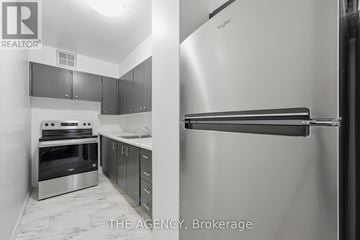 Toronto (High Park North) condo for rent - A kitchen with a stainless steel refrigerator and oven.