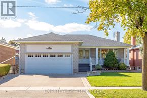 Toronto (Willowridge-Martingrove-Richview) apartment for rent - A house with a white garage door is for sale.