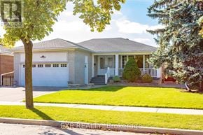 Toronto (Willowridge-Martingrove-Richview) apartment for rent - A house with a white garage door and a tree in front.