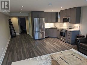 Toronto (Willowridge-Martingrove-Richview) apartment for rent - A kitchen with a refrigerator, oven, and microwave.