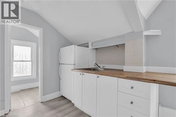 Cambridge apartment for rent - A kitchen with white cabinets and a wooden countertop.