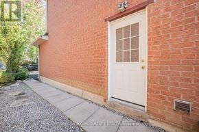 Richmond Hill (Devonsleigh) apartment for rent - A red brick house with a white door and a small garden.