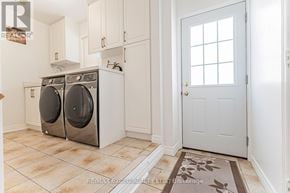 Richmond Hill (Devonsleigh) apartment for rent - A white door with a window is in a room with a tiled floor and a rug.