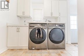 Richmond Hill (Devonsleigh) apartment for rent - A realtor's photo of a modern kitchen with a washer and dryer.