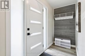 Halton Hills (Georgetown) apartment for rent - A bathroom with a white door and a grey wall.