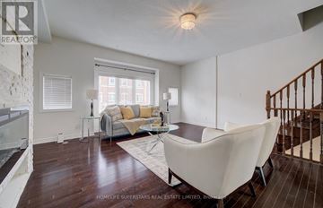 Brampton (Credit Valley) townhouse for rent - A living room with a white couch and a glass table.