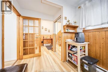 Windsor apartment for rent - A living room with a brown leather couch and a wooden floor.