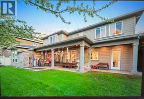 Richmond apartment for rent - A house with a well-maintained lawn and a covered patio area.