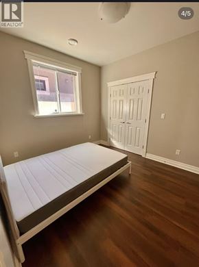 Richmond apartment for rent - A bedroom with a bed, window, and door.