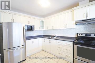 Toronto (Woodbine-Lumsden) apartment for rent - A kitchen with white cabinets and appliances.